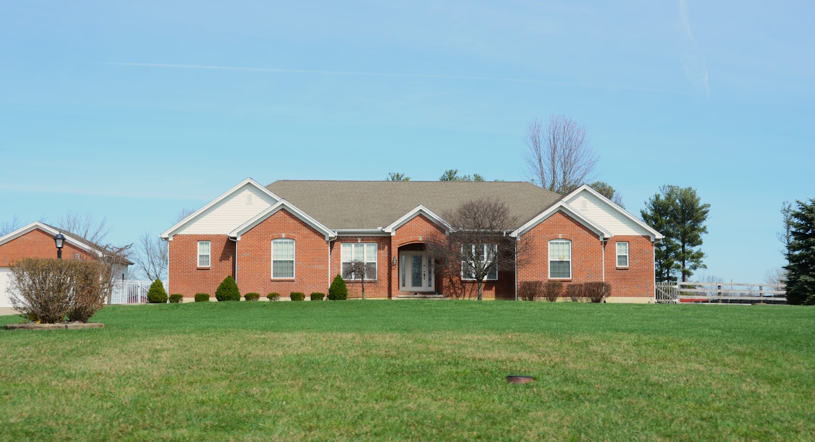 Round Rock brick home with a freshly mowed and edged front lawn after a weekly visit.